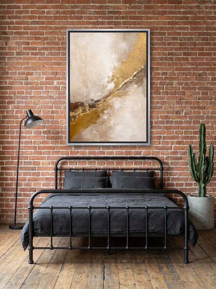 Canvas wall art with a silver leaf surround styled on the wall in an industrial loft bedroom