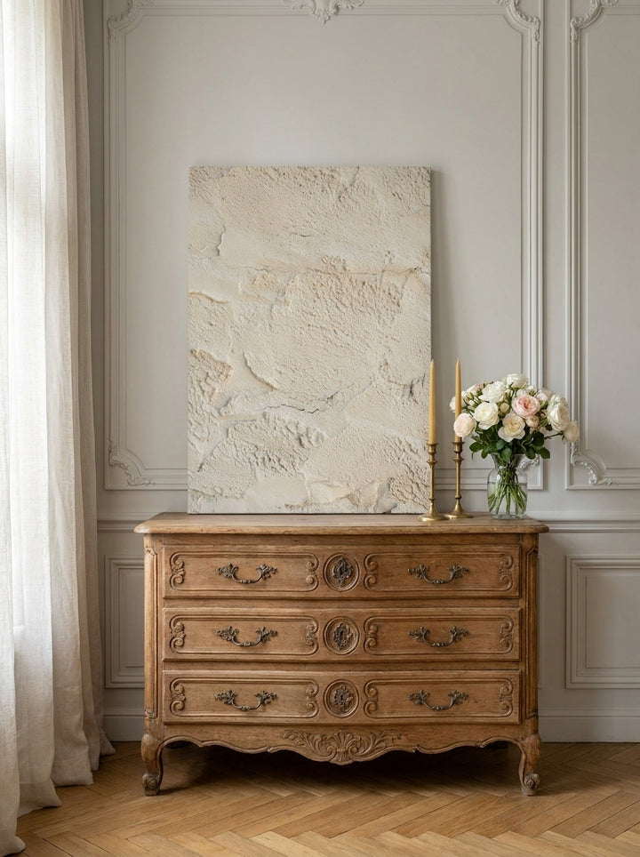 Stretched canvas wall art standing on a sideboard in a Parisian bathroom