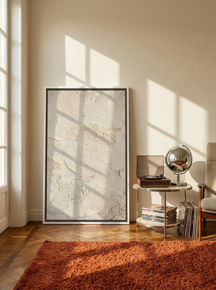 Oversized statement canvas wall art with a white surround leaning against the wall in a retro 70s living room