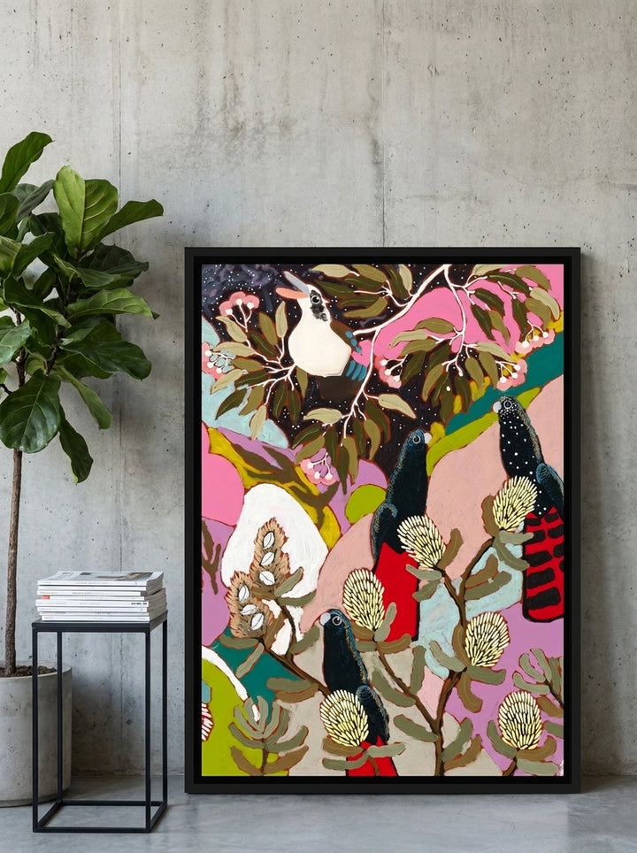 Canvas wall art with a black surround leaning against the wall in an industrial loft living room