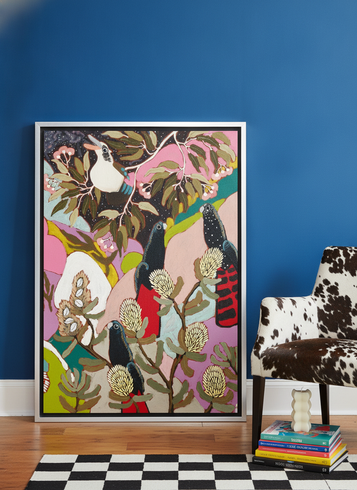 Canvas wall art with a silver leaf surround leaning against the wall in a colourful eclectic dining room