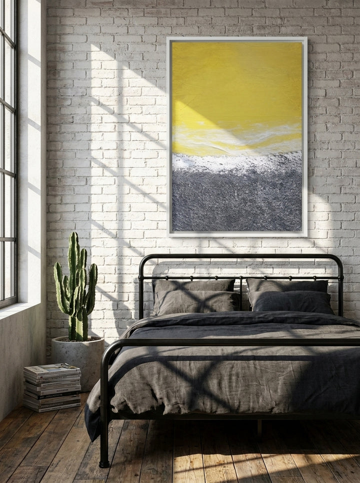 Canvas wall art with a white surround styled on the wall in an industrial loft bedroom