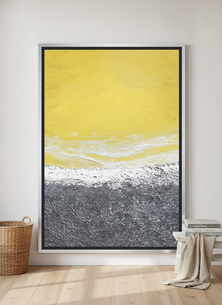 Oversized statement canvas wall art with a silver leaf surround leaning against the wall in a coastal dining room
