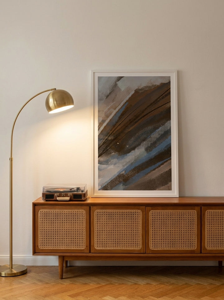 Modern wall art print standing on a sideboard in a mid-century bedroom