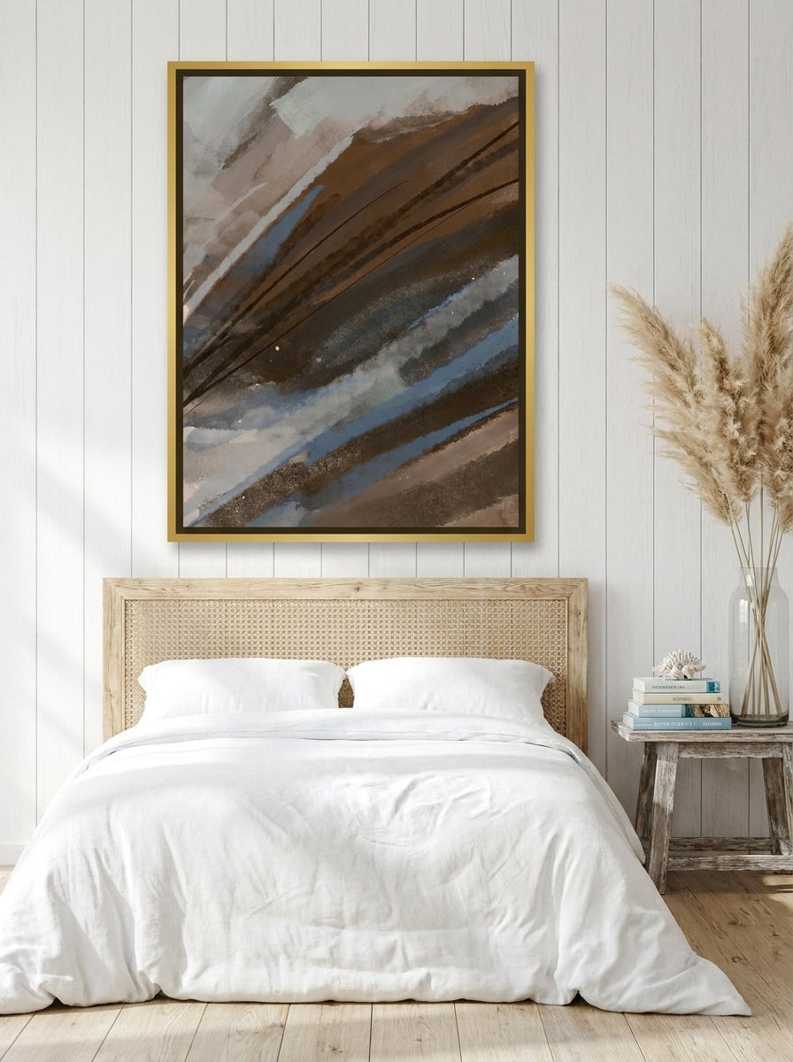 Canvas wall art with a gold leaf surround styled on the wall in a coastal bedroom