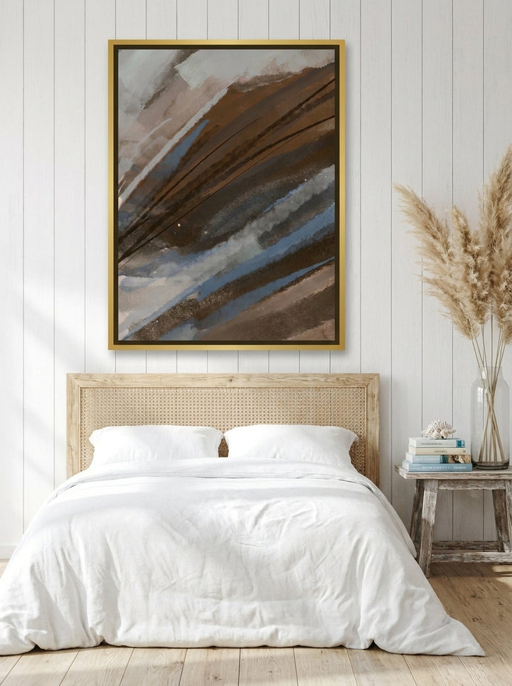 Canvas wall art with a gold leaf surround styled on the wall in a coastal bedroom