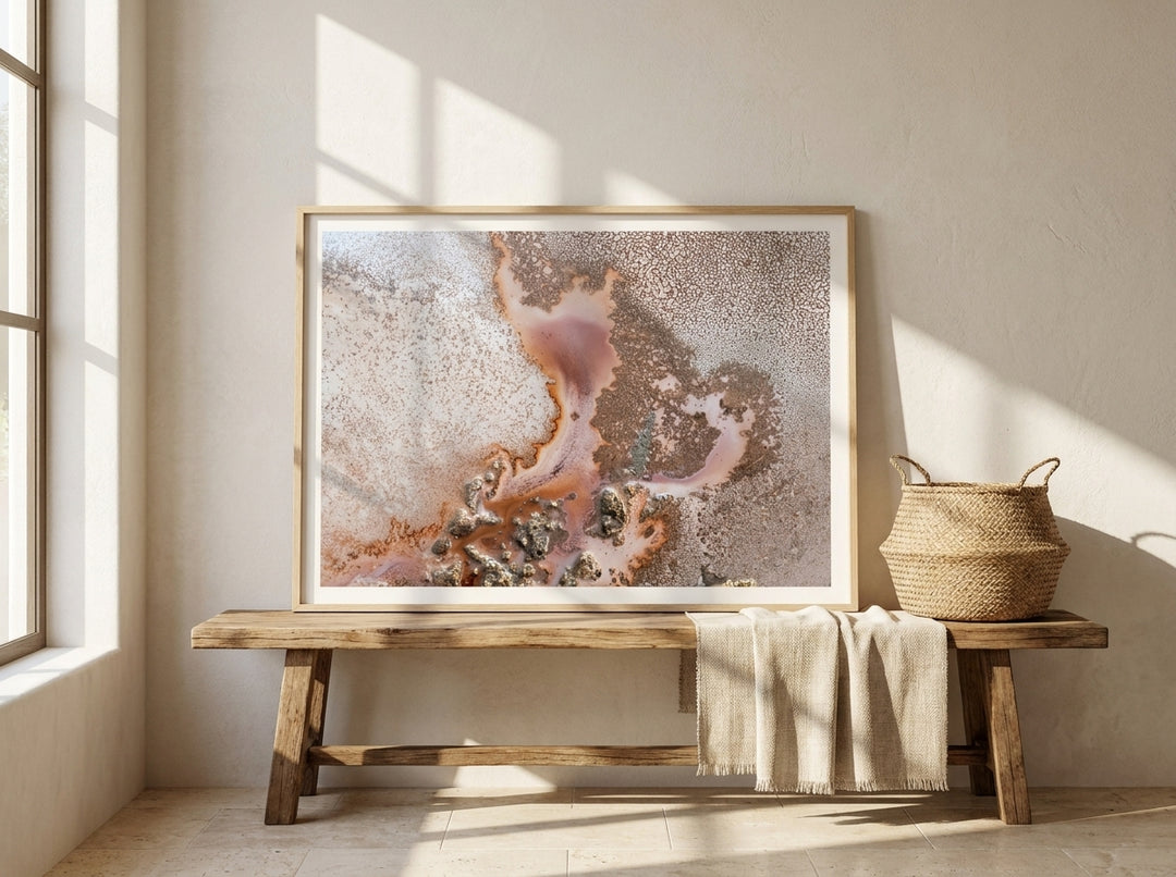 Modern wall art print standing on a bench in a Mediterranean bathroom