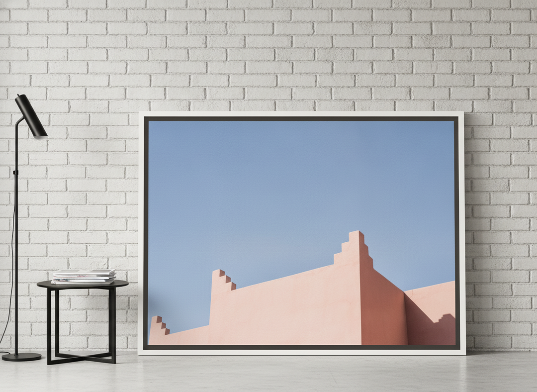 Canvas wall art with a white surround leaning against the wall in an industrial loft home office