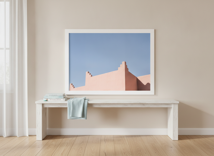 Modern wall art print standing on a console in a coastal bedroom
