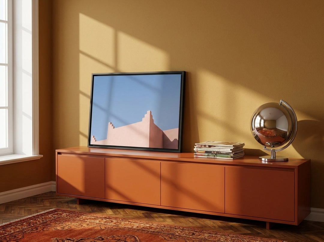 Canvas wall art with a black surround standing on a sideboard in a retro 70s living room