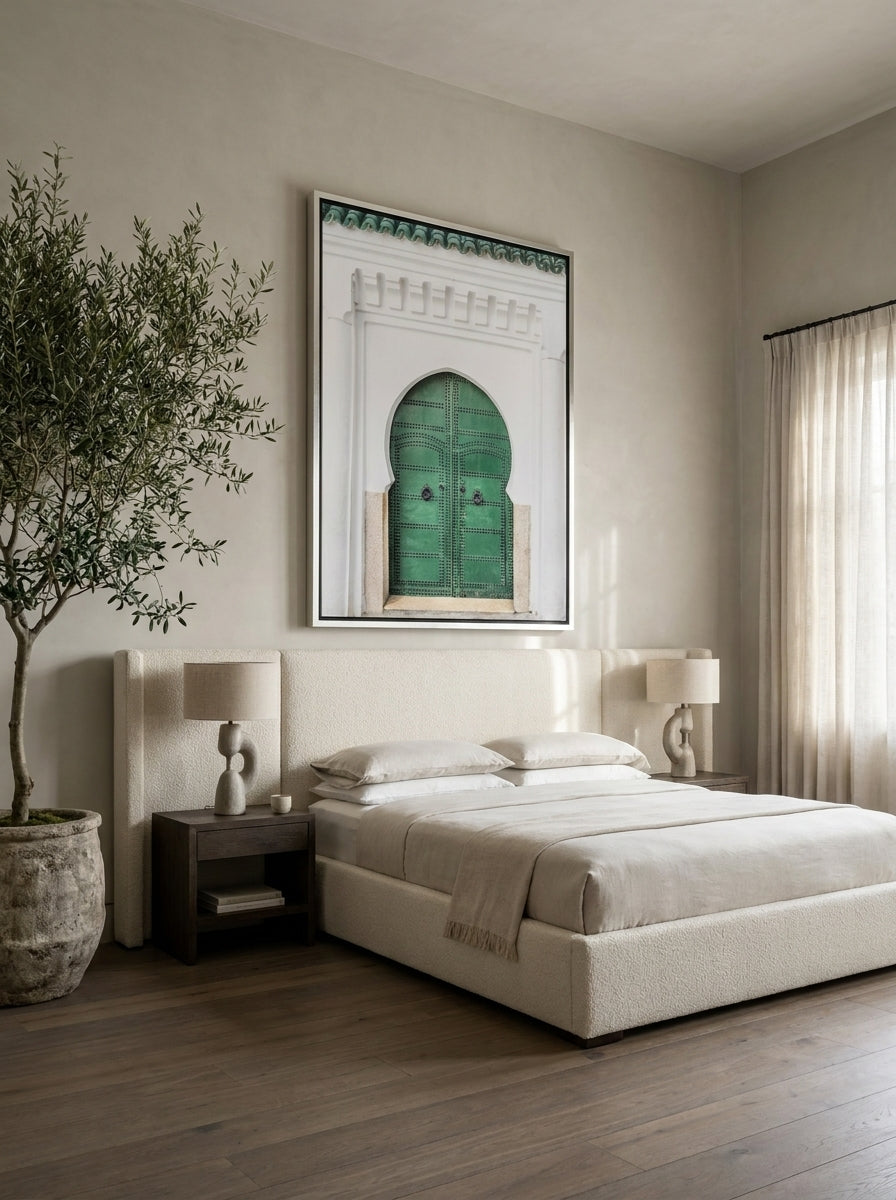 Oversized statement canvas wall art with a silver leaf surround styled on the wall in a luxe bedroom