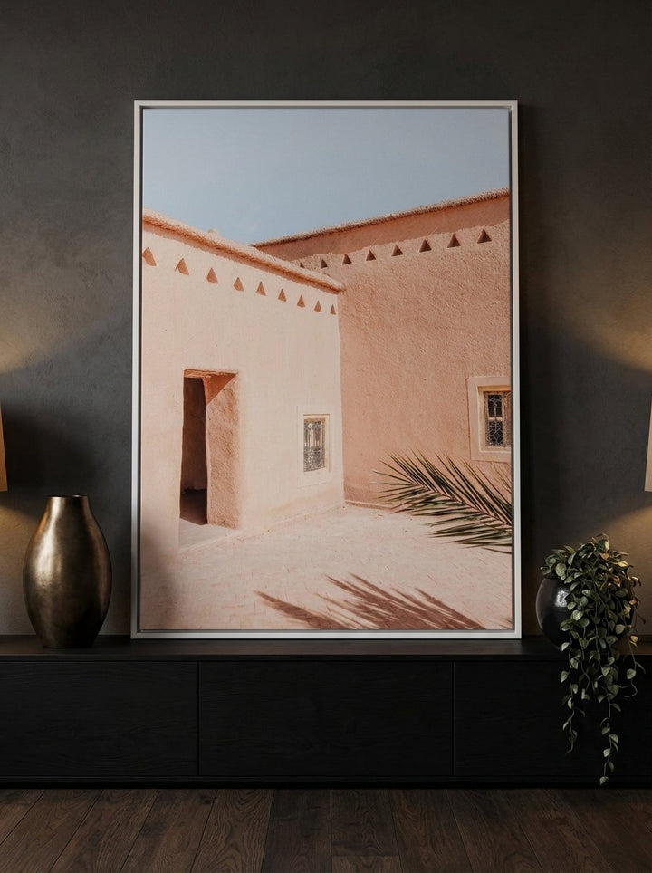 Canvas wall art with a white surround standing on a console in a moody bedroom