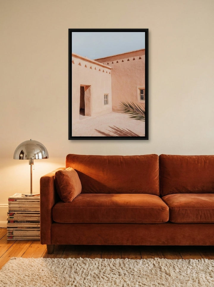 Canvas wall art with a black surround styled on the wall in a retro 70s living room
