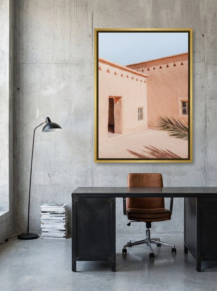 Canvas wall art with a gold leaf surround styled on the wall in an industrial loft home office