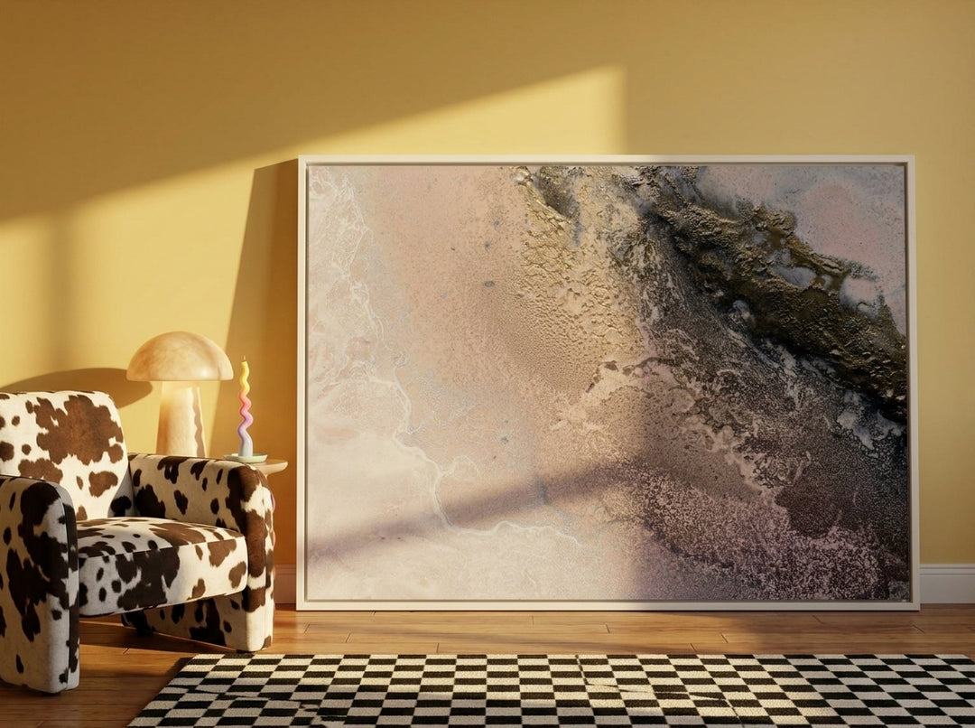 Oversized statement canvas wall art with a white surround leaning against the wall in a colourful eclectic dining room