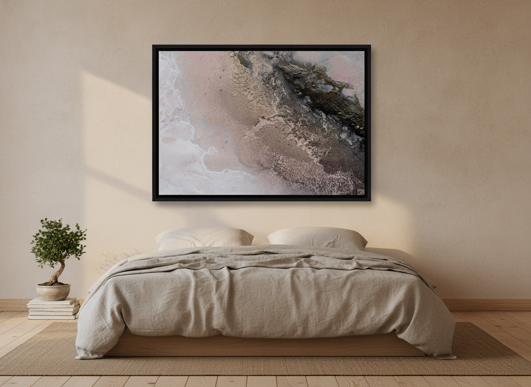 Canvas wall art with a black surround styled on the wall in a warm Japandi bedroom