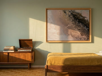 Modern wall art print styled on the wall in a mid-century bedroom