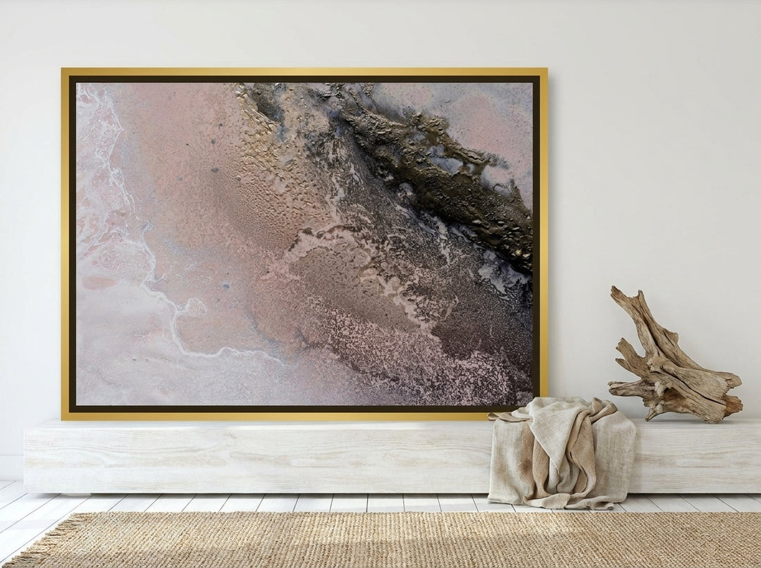 Canvas wall art with a gold leaf surround standing on a console in a coastal living room