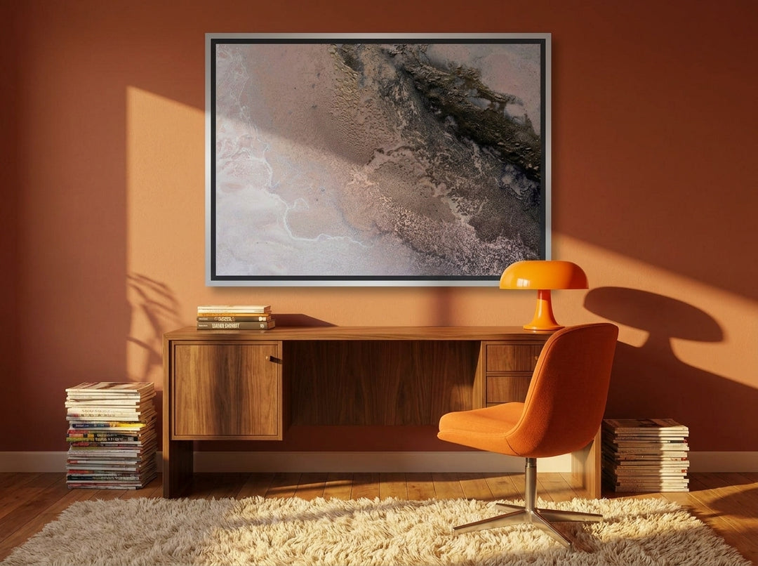 Canvas wall art with a silver leaf surround styled on the wall in a retro 70s home office
