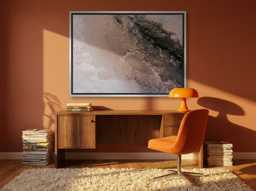 Canvas wall art with a silver leaf surround styled on the wall in a retro 70s home office