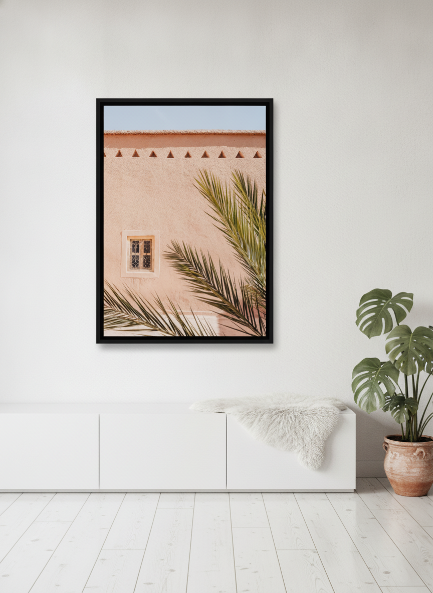 Canvas wall art with a black surround styled on the wall in a bright Scandinavian living room
