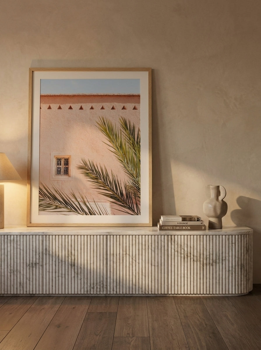 Modern wall art print standing on a sideboard in a luxe living room