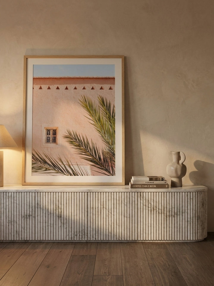 Modern wall art print standing on a sideboard in a luxe living room