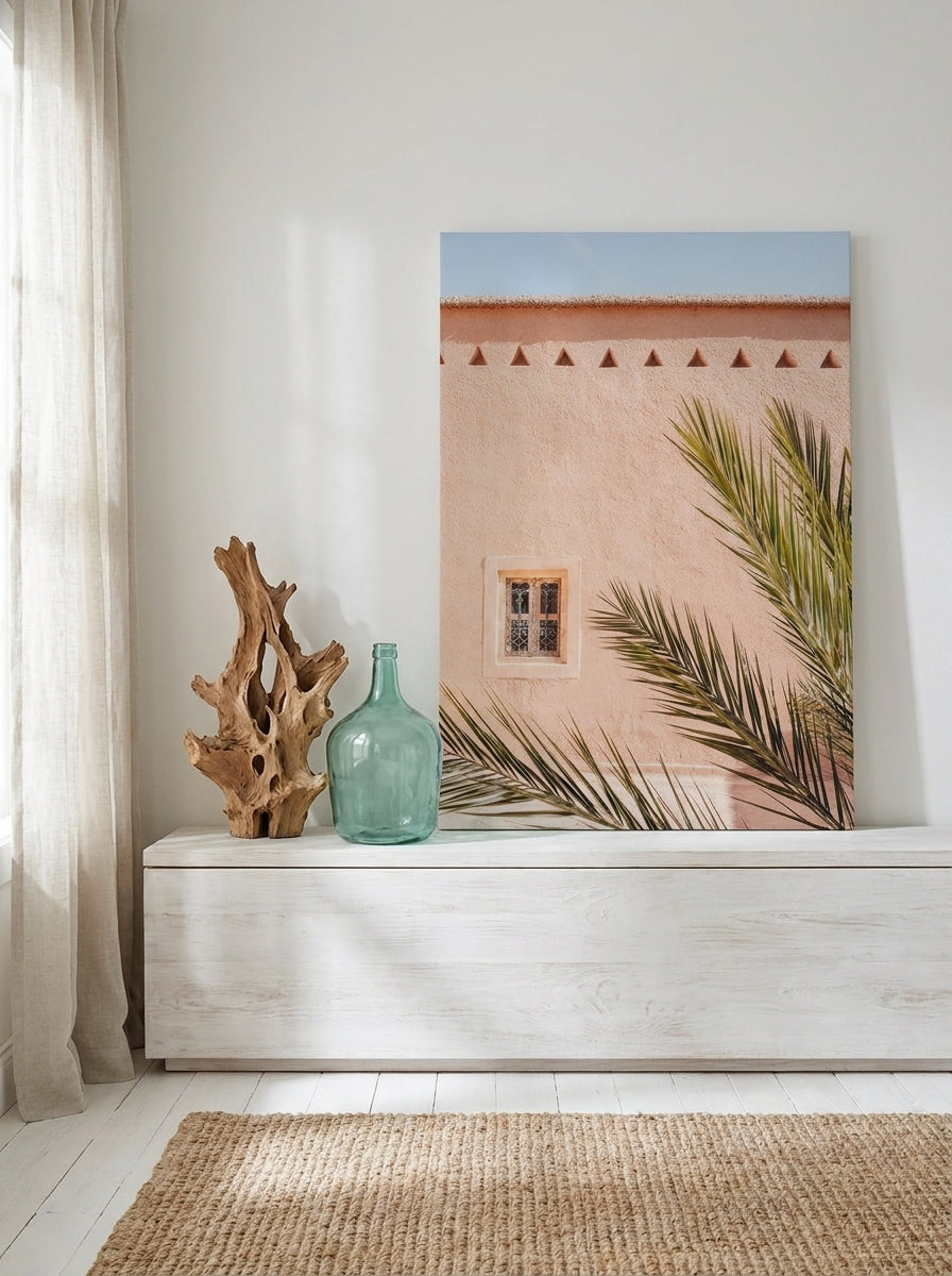 Stretched canvas wall art standing on a console in a coastal living room