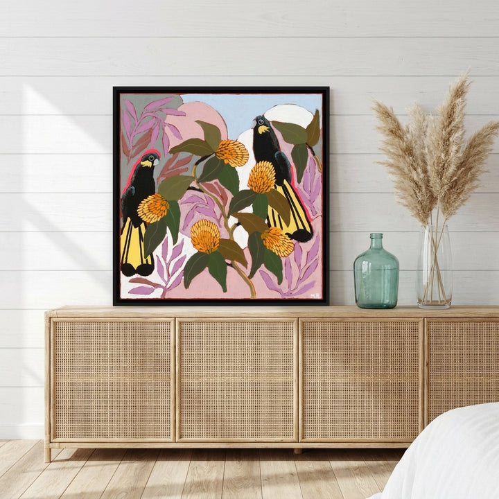 Canvas wall art with a black surround standing on a sideboard in a coastal bedroom