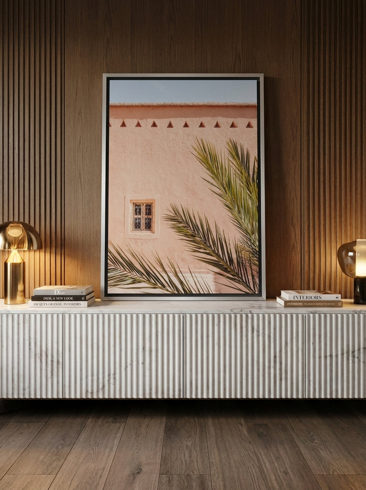 Canvas wall art with a silver leaf surround standing on a sideboard in a luxe living room