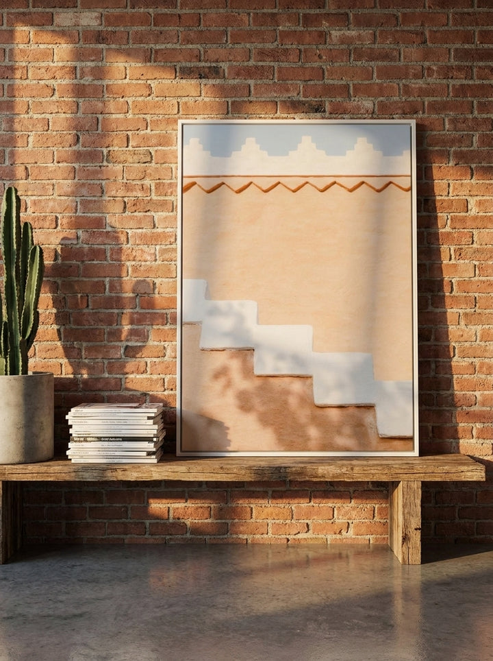 Canvas wall art with a white surround standing on a bench in an industrial loft bedroom