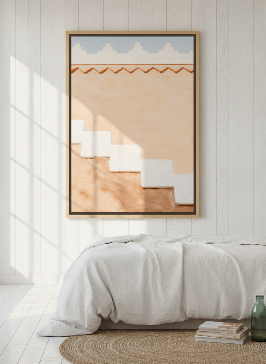 Oversized statement canvas wall art with a natural timber surround styled on the wall in a coastal bedroom