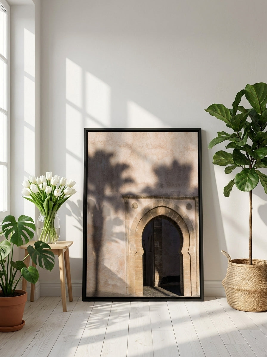 Canvas wall art with a black surround leaning against the wall in a bright Scandinavian living room