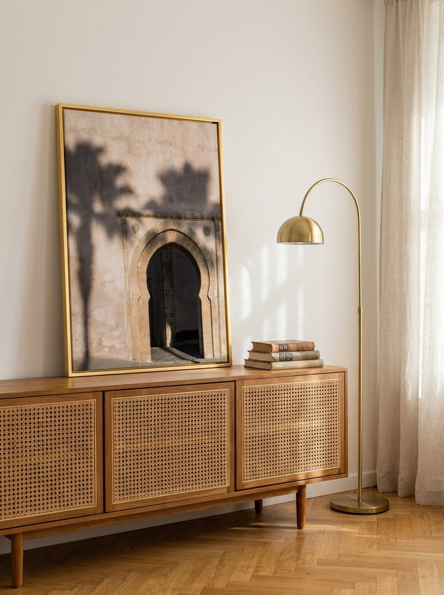 Canvas wall art with a gold leaf surround standing on a sideboard in a mid-century bedroom