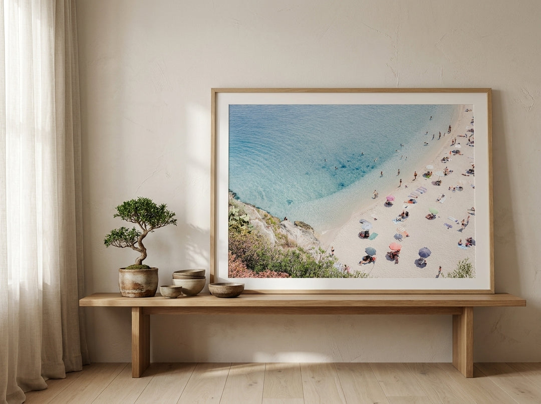 Modern wall art print standing on a bench in a warm Japandi bathroom