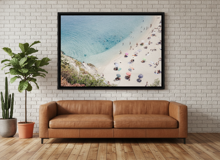 Oversized statement canvas wall art with a black surround styled on the wall in an industrial loft living room