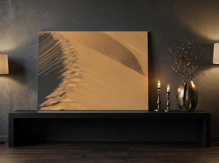 Stretched canvas wall art standing on a console in a moody home office
