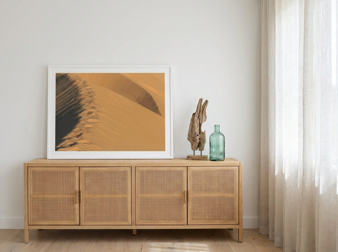 Modern wall art print standing on a sideboard in a coastal home office