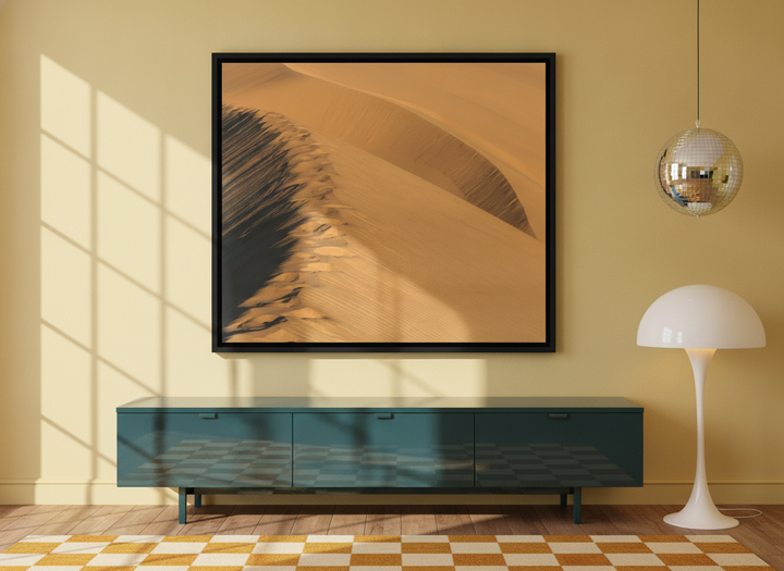 Canvas wall art with a black surround styled on the wall in a colourful eclectic living room