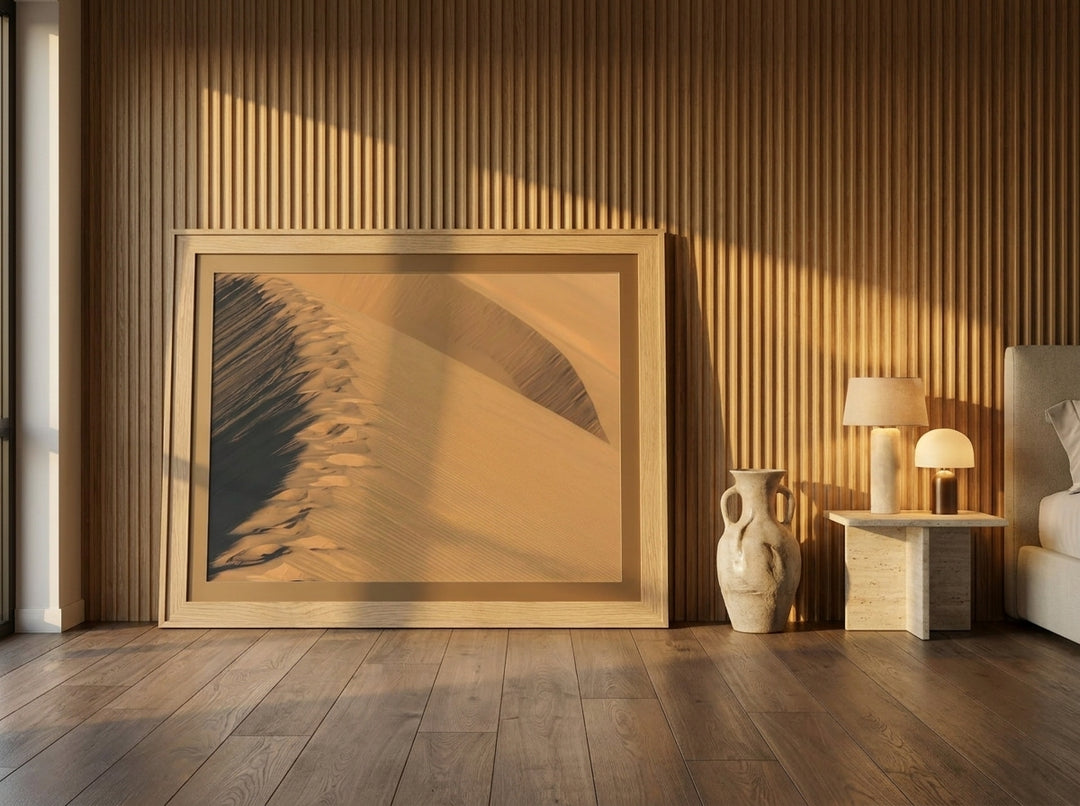 Oversized statement modern wall art print leaning against the wall in a luxe bedroom