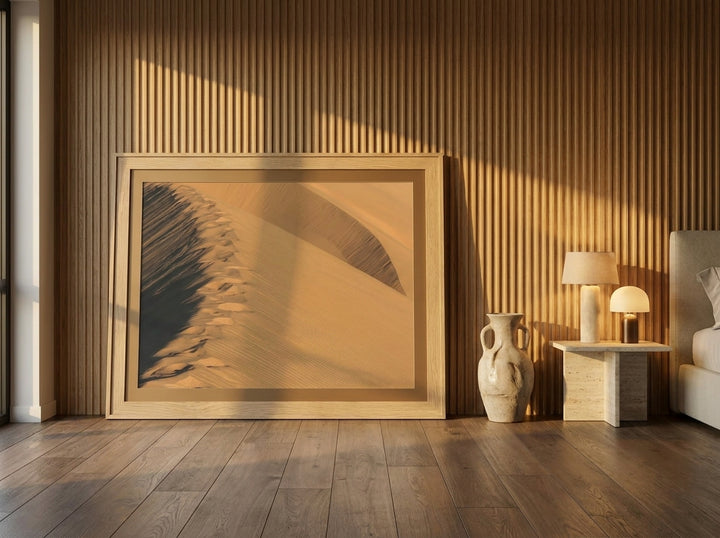 Oversized statement modern wall art print leaning against the wall in a luxe bedroom