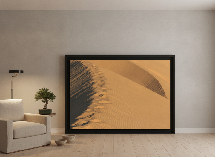 Oversized statement modern wall art print leaning against the wall in a warm Japandi bedroom