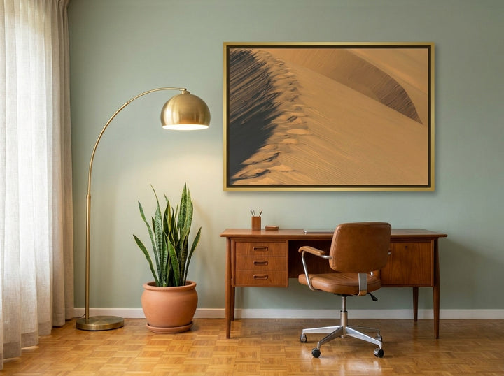 Canvas wall art with a gold leaf surround styled on the wall in a mid-century home office