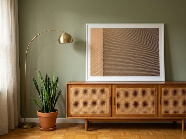Modern wall art print standing on a sideboard in a mid-century bedroom