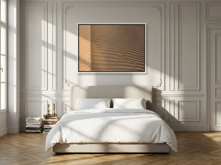 Canvas wall art with a white surround styled on the wall in a Parisian bedroom