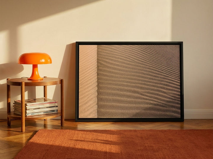 Canvas wall art with a black surround leaning against the wall in a retro 70s living room