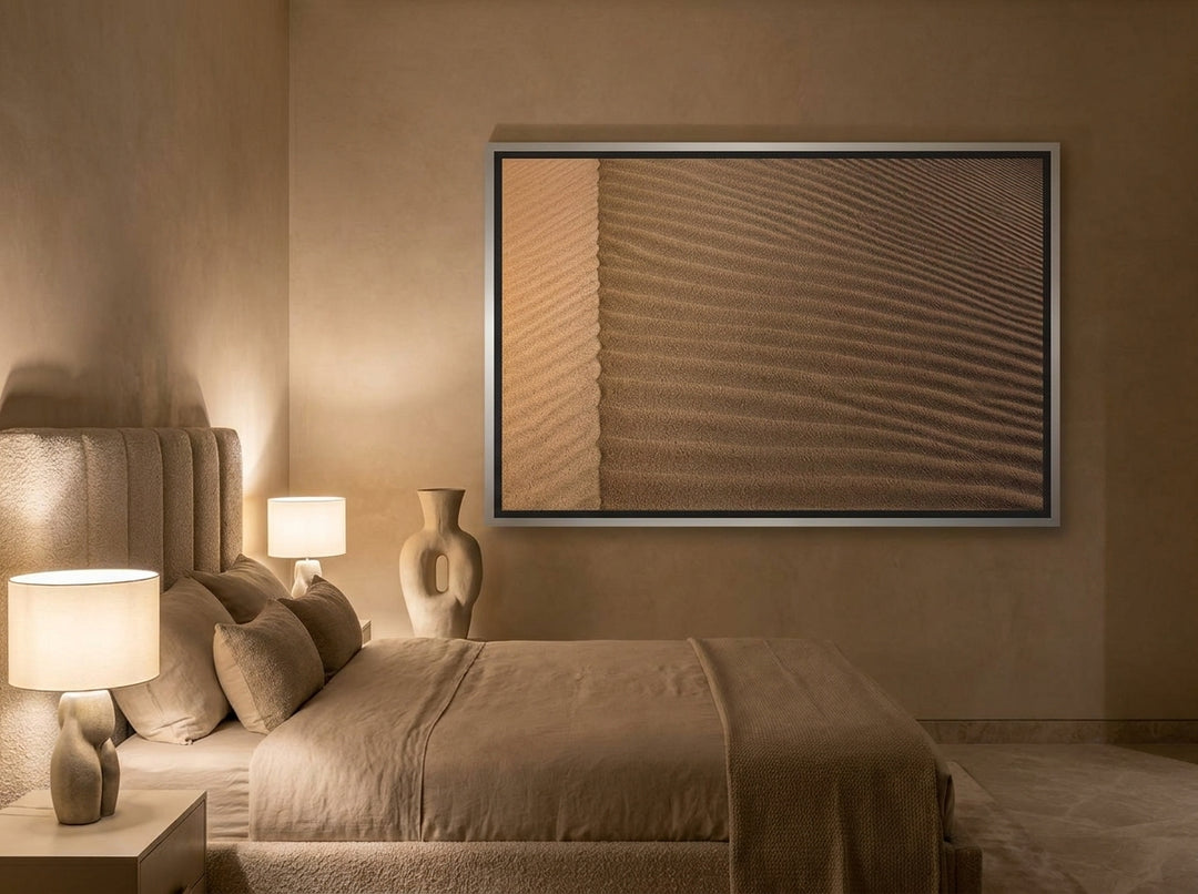 Oversized statement canvas wall art with a silver leaf surround styled on the wall in a luxe bedroom
