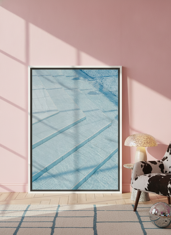 Canvas wall art with a white surround leaning against the wall in a colourful eclectic home office