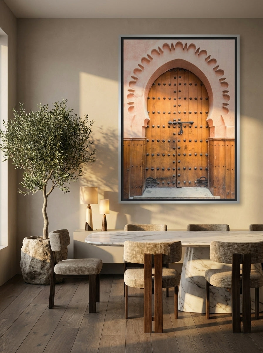 Oversized statement canvas wall art with a silver leaf surround styled on the wall in a luxe dining room
