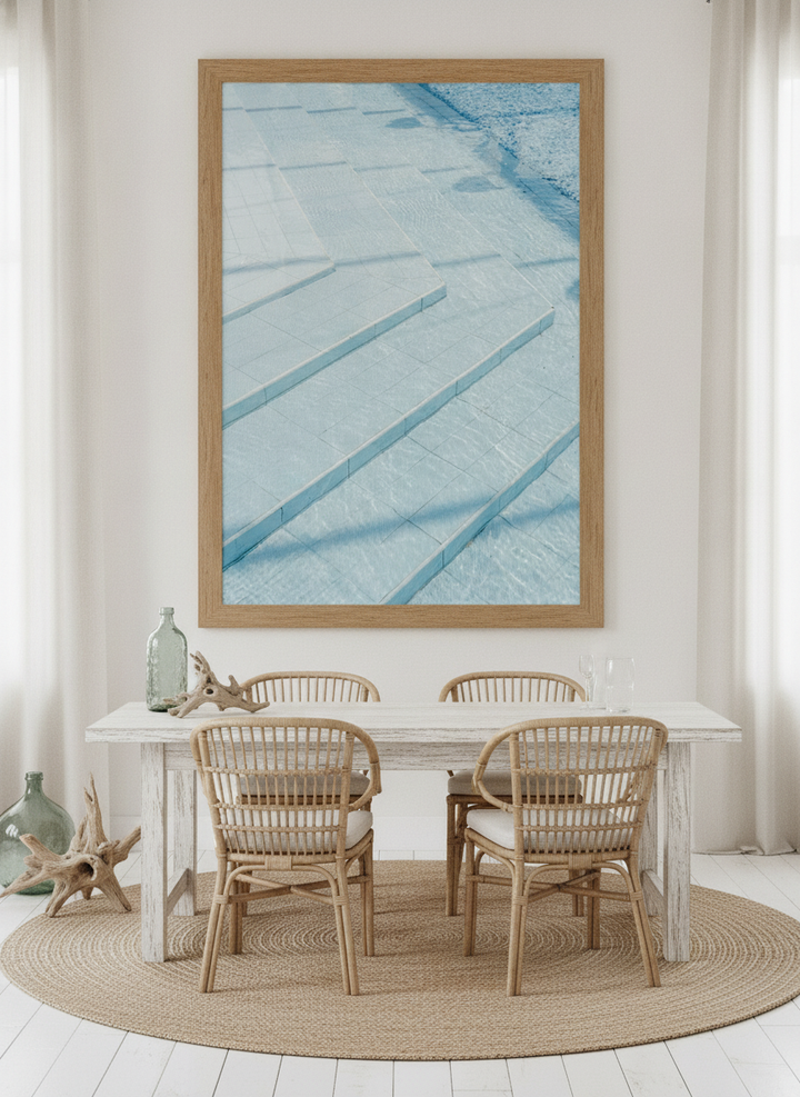 Oversized statement modern wall art print styled on the wall in a coastal dining room